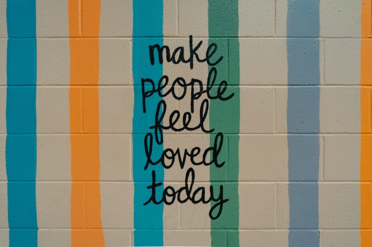blended family quote written on a wall, it says make people feel loved today